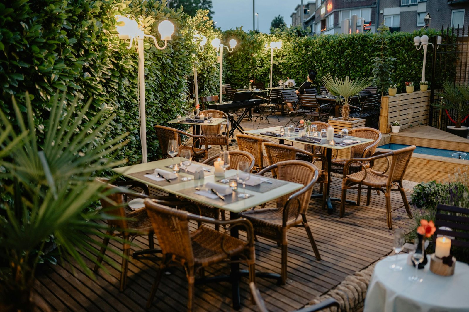 Inviting outdoor dining with warm lighting on a cozy restaurant terrace, perfect for evening meals.